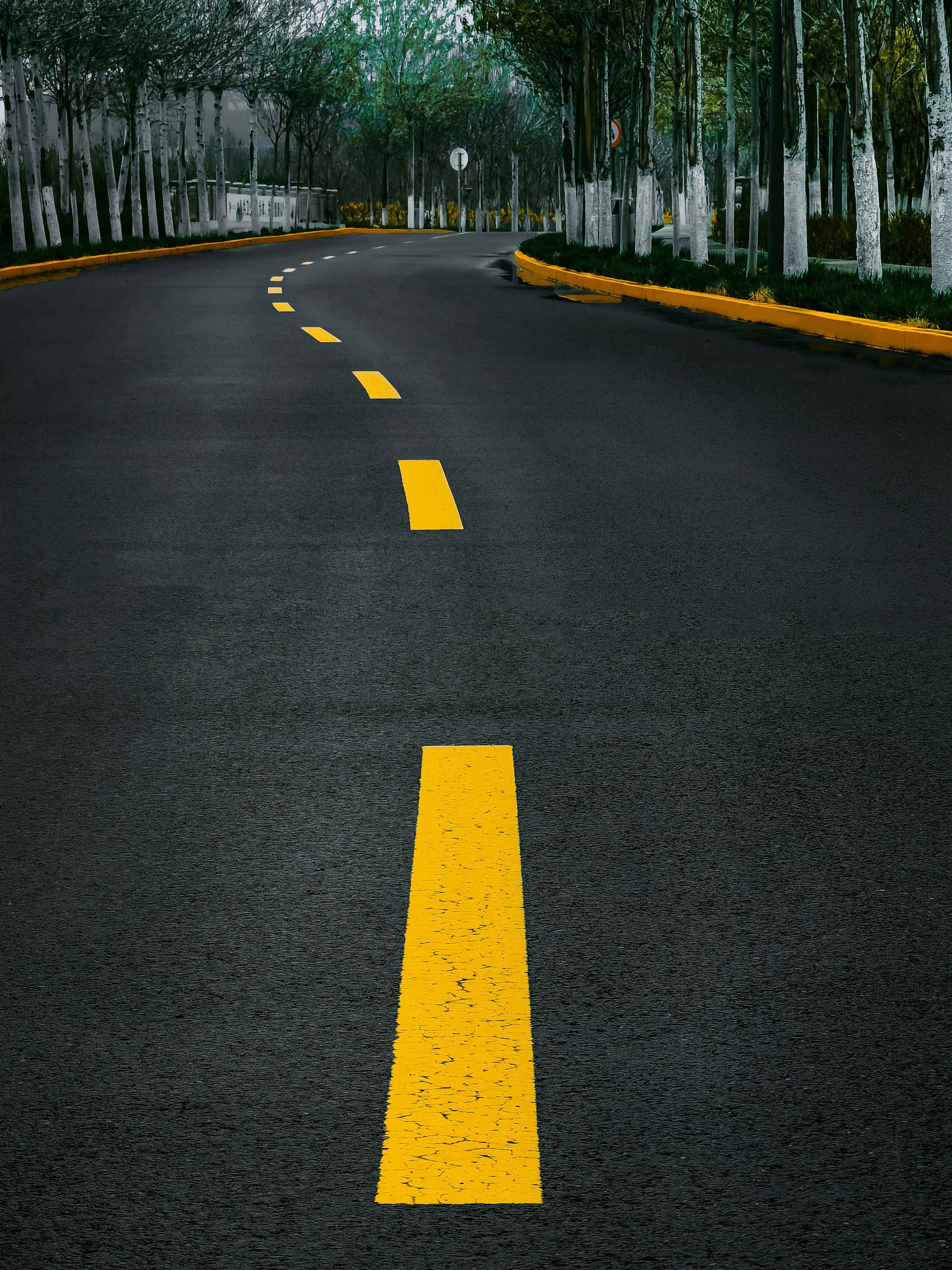 Yellow line on gray asphalt road